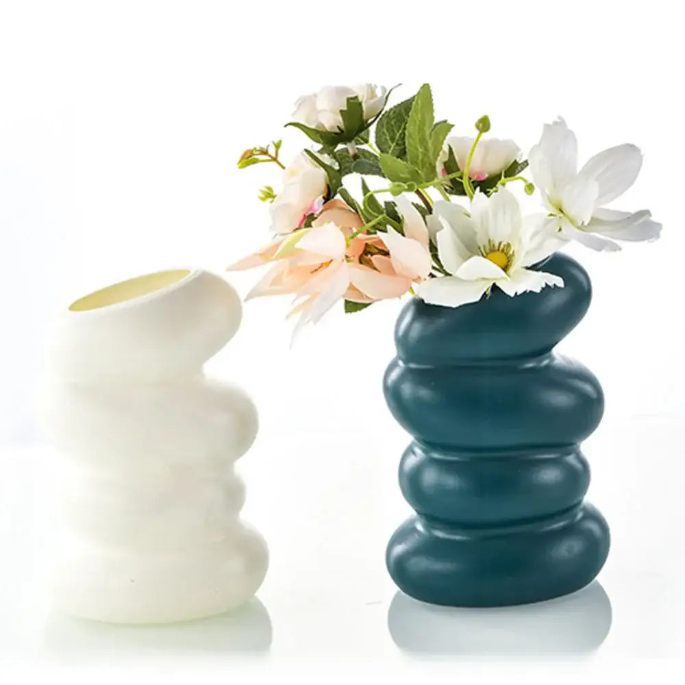 Teal ceramic nordic flower vase with stacked rounded segments holding white and pink flowers for modern home decor