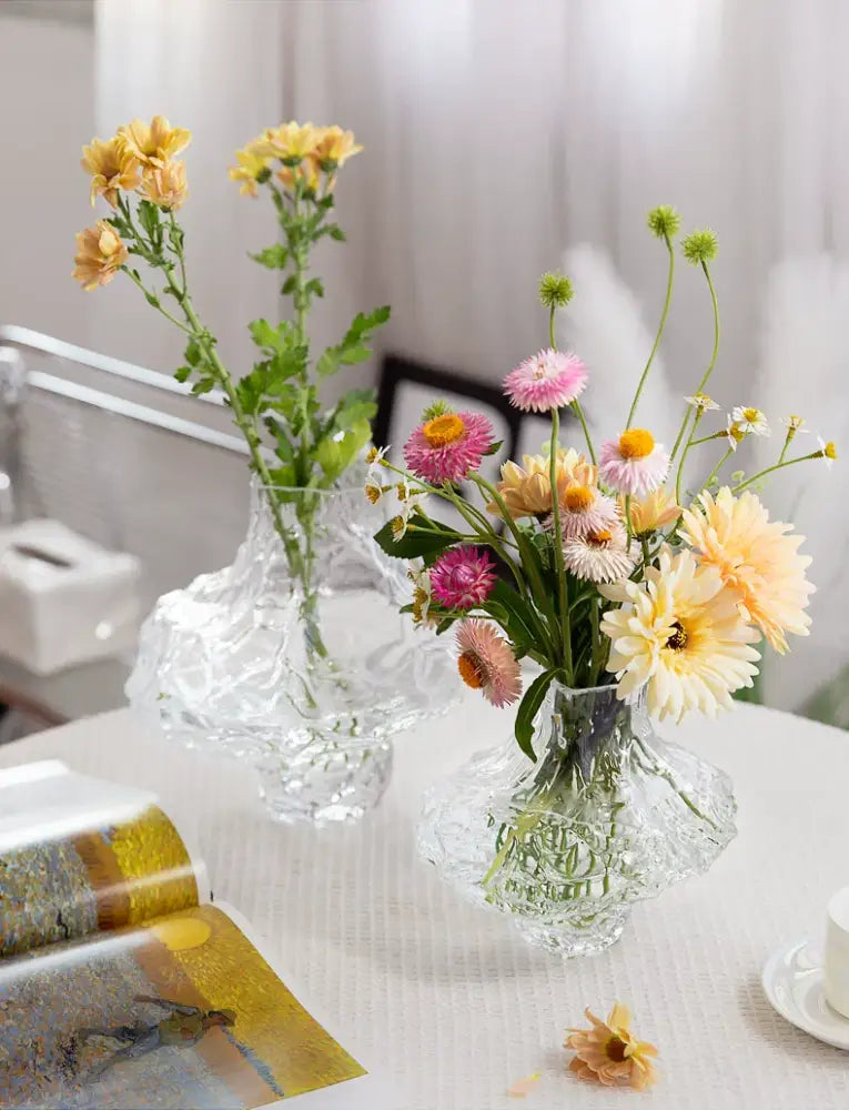 Decorbites™ nordic frosting glass vase is a clear intricately cut frosting glass vase holding vibrant colorful flowers