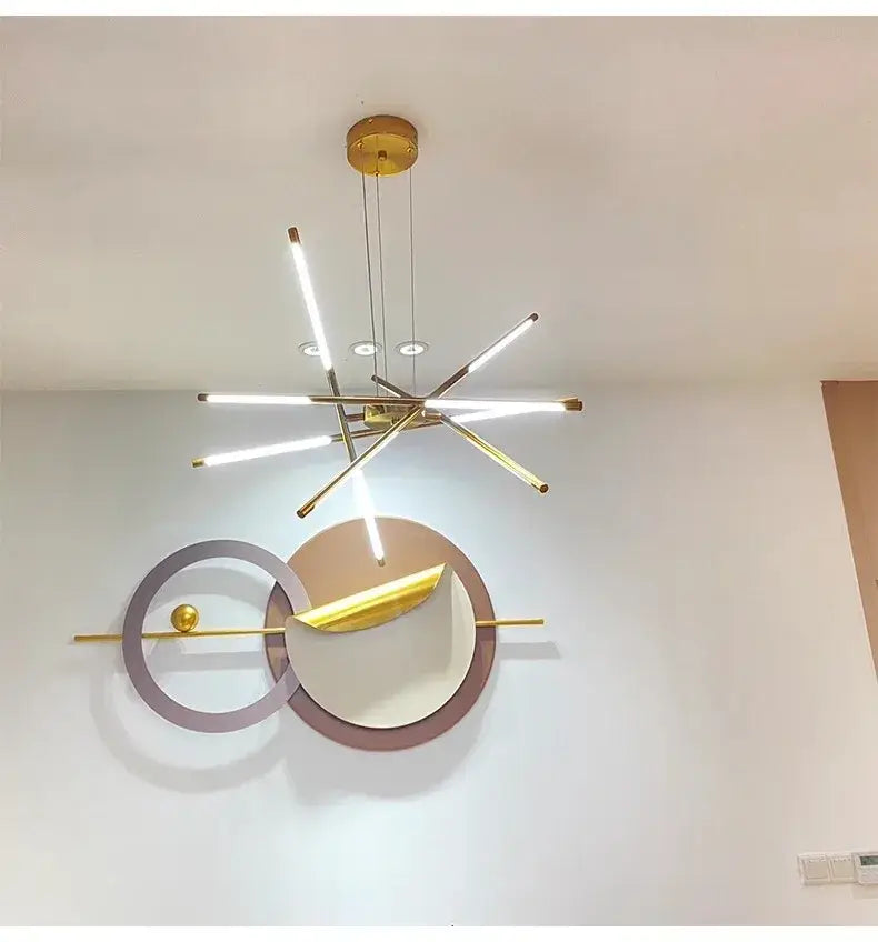 Modern gold-toned led chandelier with slender illuminated rods and remote control featuring nordic geometry design