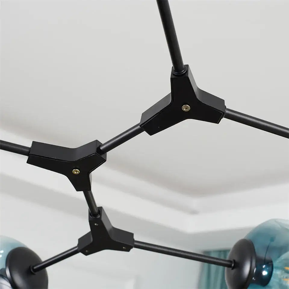 Black metal nordic glass ball led chandelier with geometric tripod connectors and teal glass ball fixtures by DecorBites