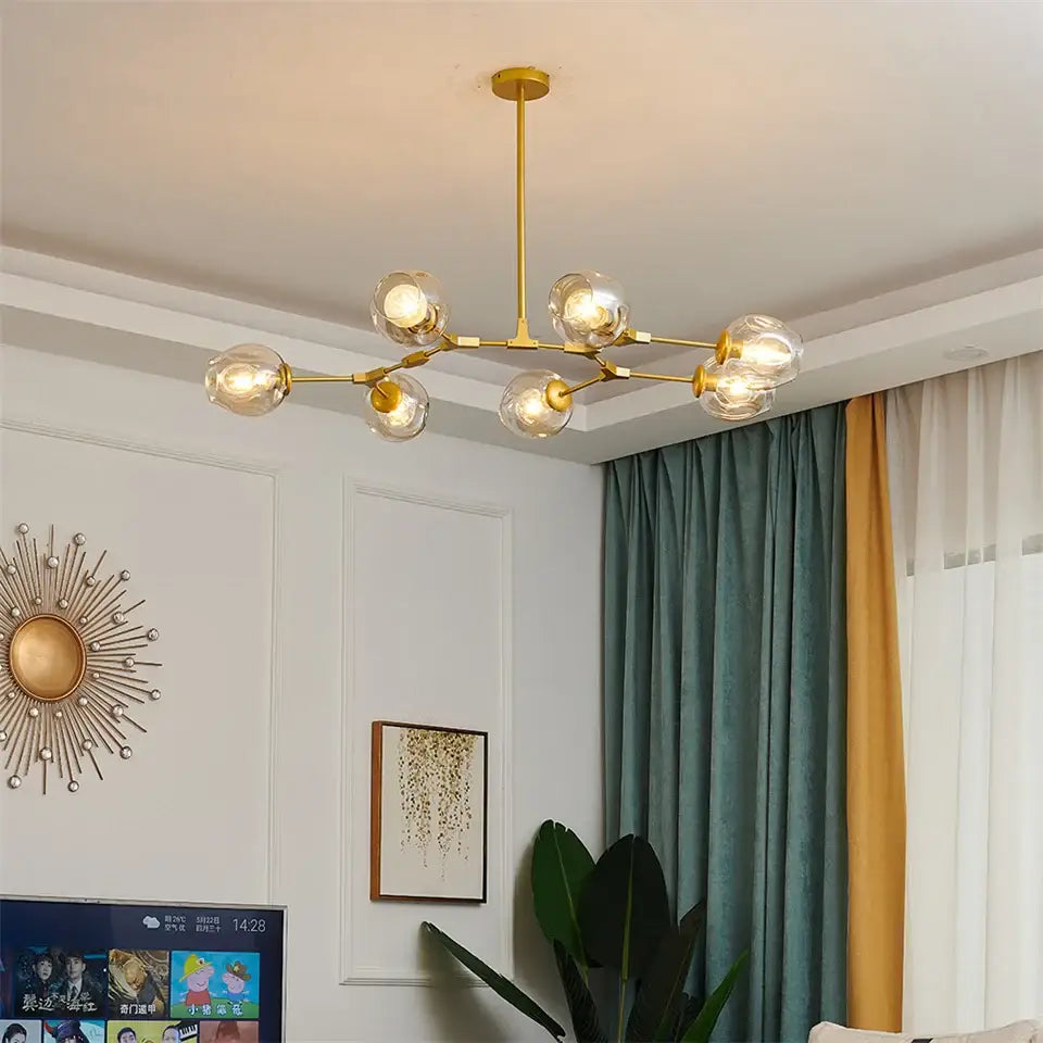 Gold-toned nordic glass ball led chandelier with six clear glass globe bulbs in black and gold finish