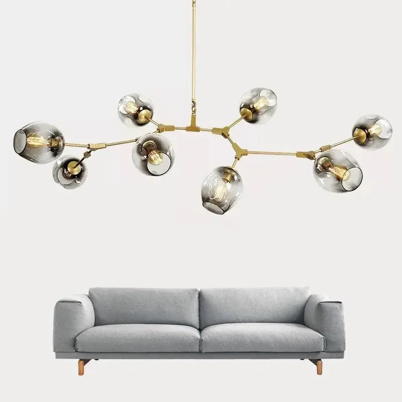Modern brass DecorBites Nordic glass ball LED chandelier with smoked glass globe shades and exposed filament bulbs in black and gold