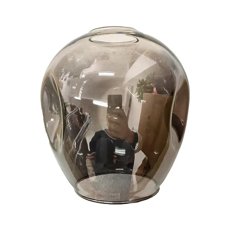 A sleek translucent amber glass ball vase with smooth reflective surface for decorbites nordic glass ball led chandelier