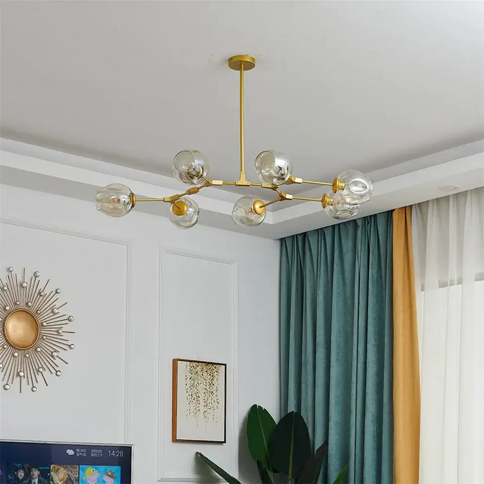 Gold-toned nordic glass ball led chandelier with six clear glass globe bulbs by DecorBites black gold design
