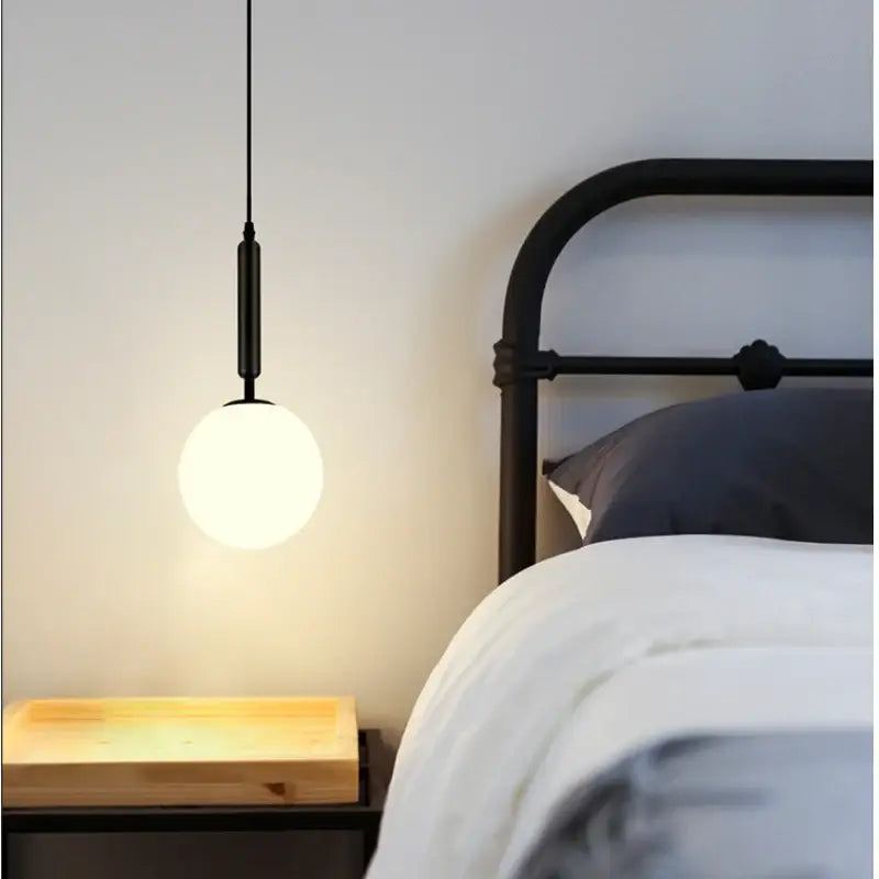Black DecorBites™ Nordic glass ball pendant light with frosted glass globe and sleek metal rod light source