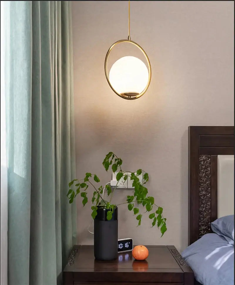 DecorBites™ Nordic glass ball pendant light with a gold-toned circular frame and frosted glass light source