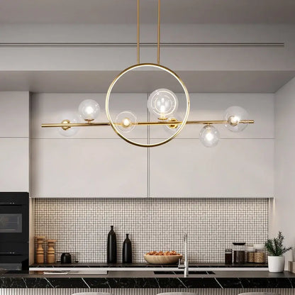 Gold-toned modern pendant light with circular frame and five clear glass bubble led globe bulbs in nordic style