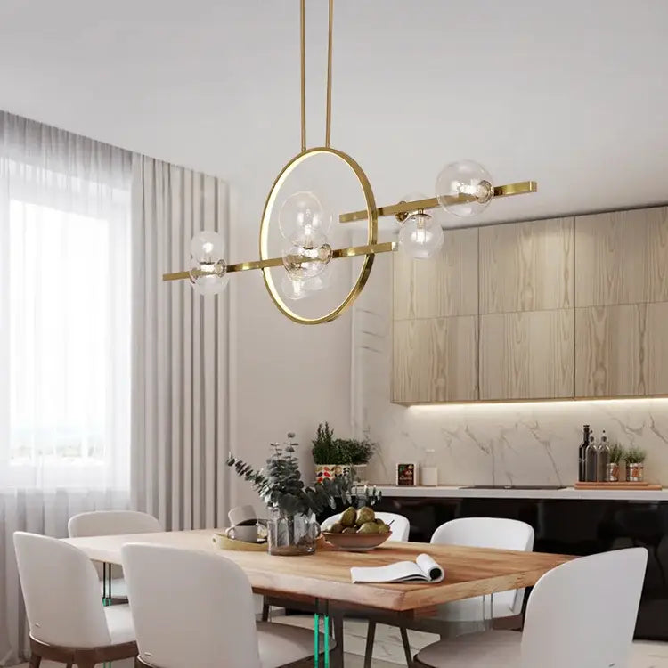 Modern gold-toned nordic glass bubble led chandelier with clear glass globe bulbs and sleek minimalist design by DecorBites