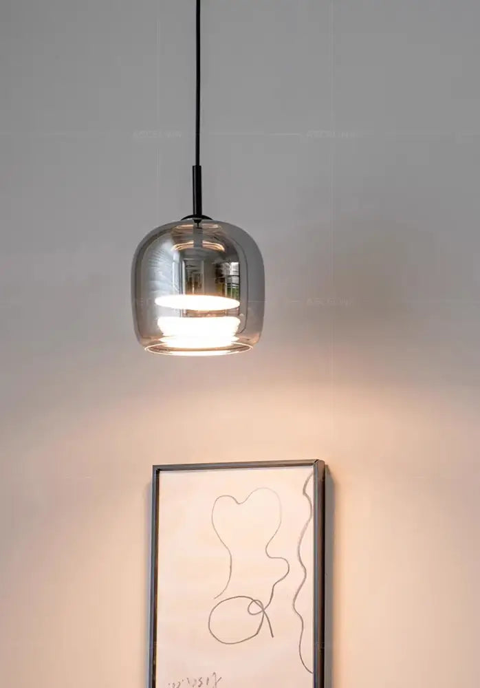 A sleek modern DecorBites nordic glass led pendant chandelier with transparent glass globe and black cord