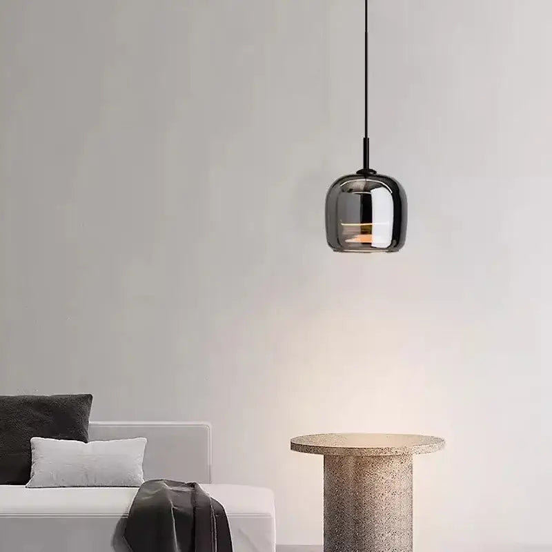 A sleek modern pendant light featuring a glossy black nordic glass led globe with a thin black cord by decorbites