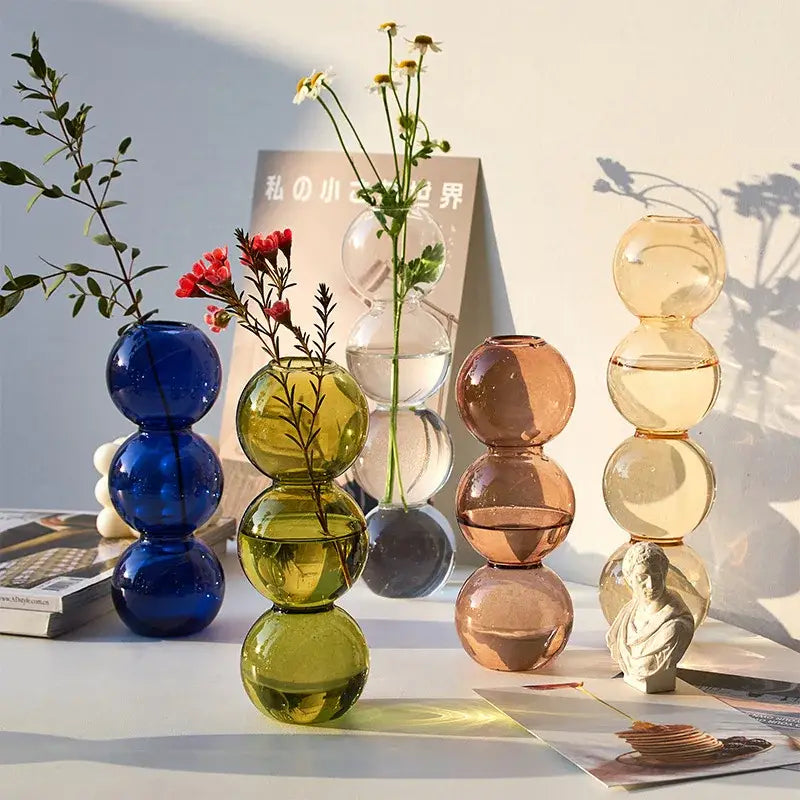 Stacked vibrant translucent blue green amber and clear nordic glass vases from decorbites™ nordic glass vase collection