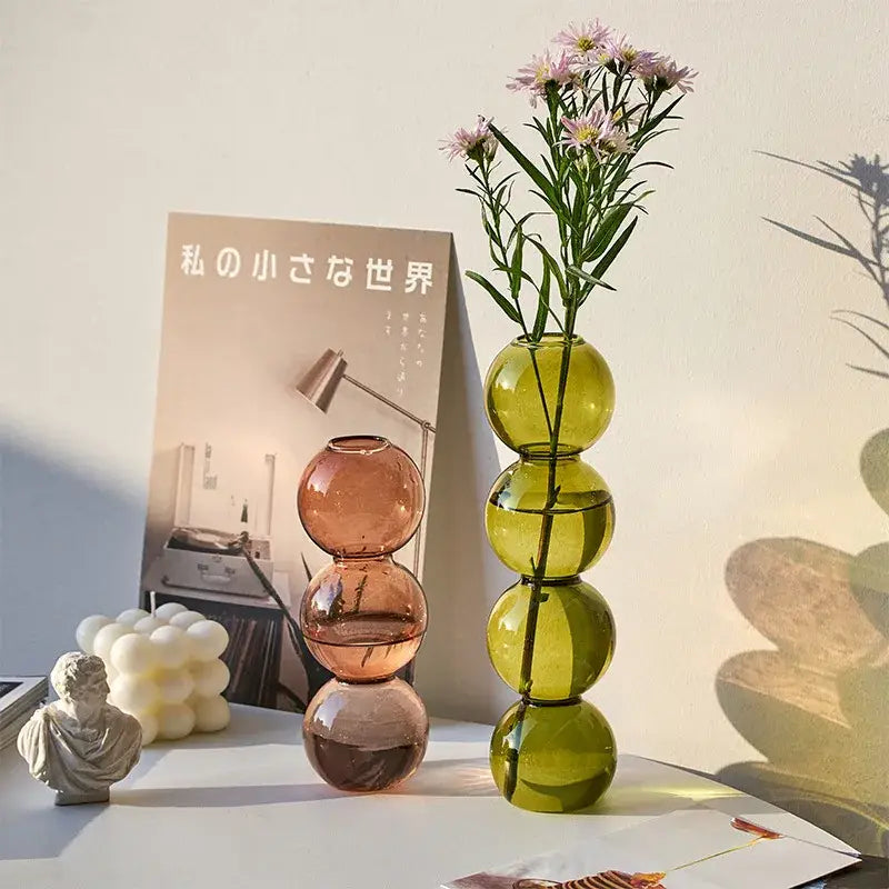 DecorBites™ nordic glass vase in translucent green with stacked sphere design holding delicate pink flowers