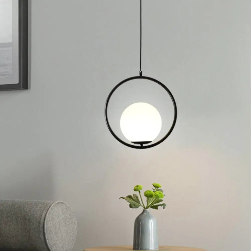 DecorBites™ nordic gold pendant light featuring a black circular pendant light with frosted white glass shade bulb