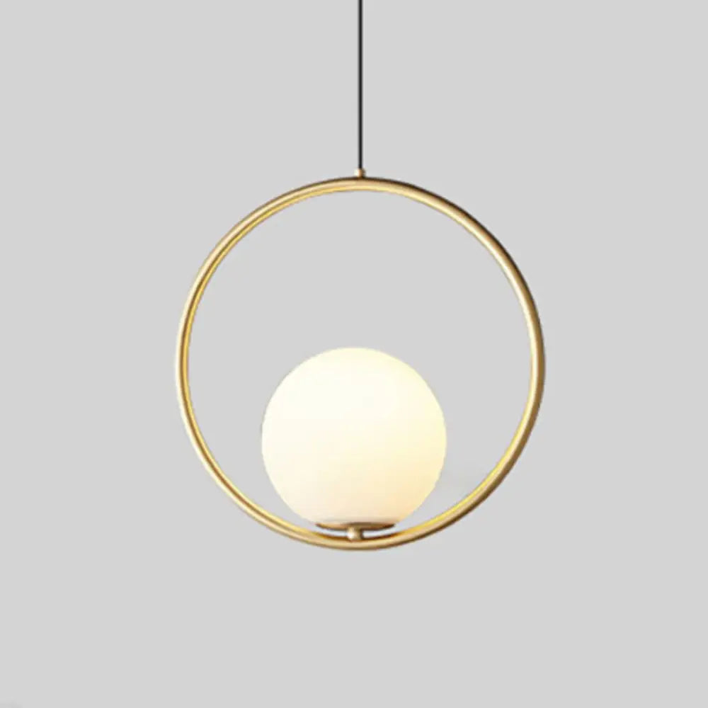 Gold-toned nordic gold pendant light with a circular frame and frosted glass shade by DecorBites pendant light