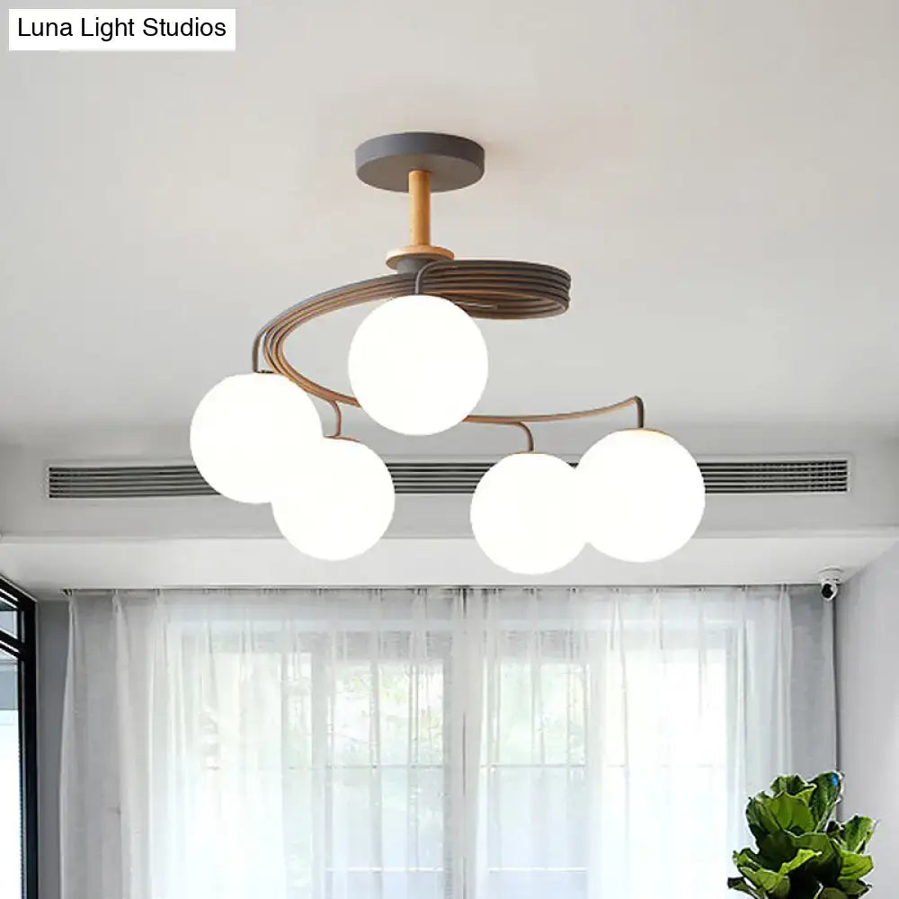 Decorbites nordic iron swirl flush chandelier with five orb glass shades on a grey metal frame with wood accents
