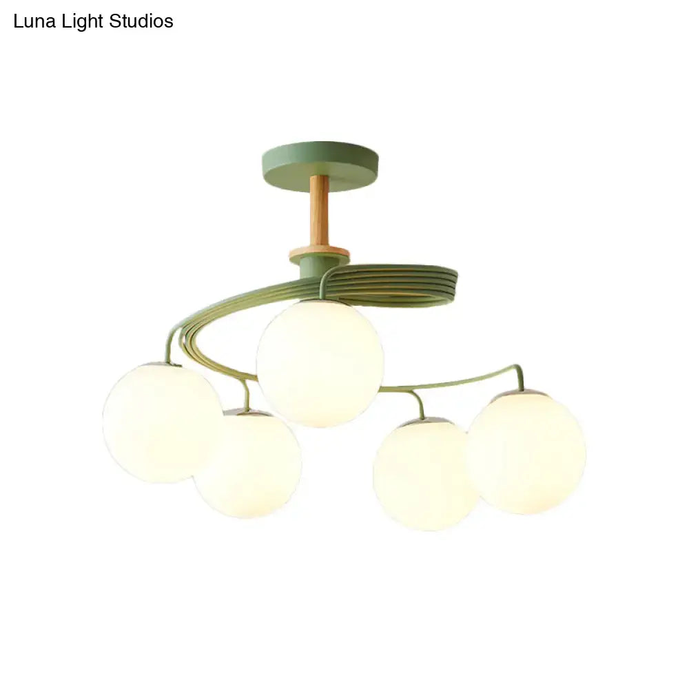 DecorBites™ Nordic iron swirl semi flush ceiling light with five green orb glass shades and wooden downrod accents