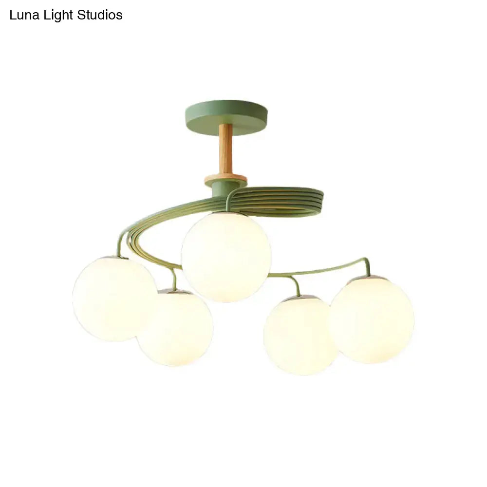 DecorBites Nordic iron swirl flush chandelier with five frosted orb glass shades, green metal, and wood downrod