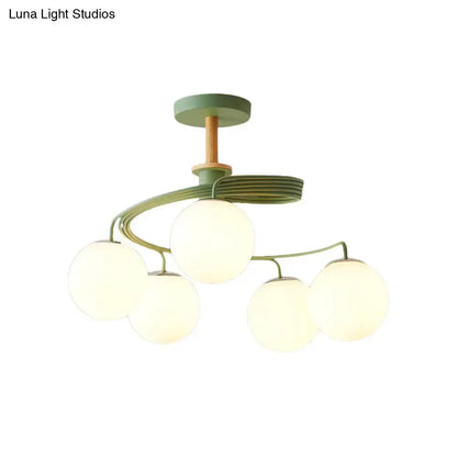DecorBites Nordic iron swirl flush chandelier with five frosted orb glass shades, green metal, and wood downrod