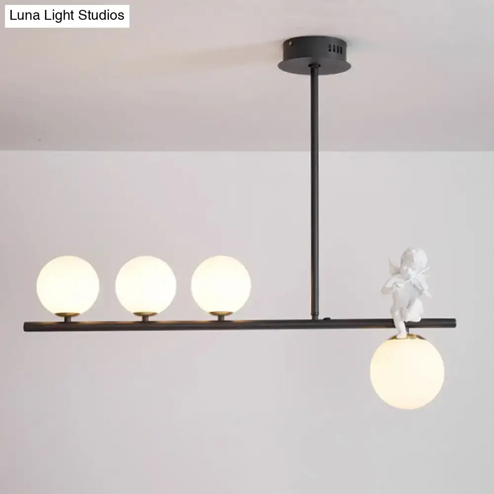Decorbites™ nordic island angel pendant light with black metal frame, opaline glass shade, and white ceramic cherub
