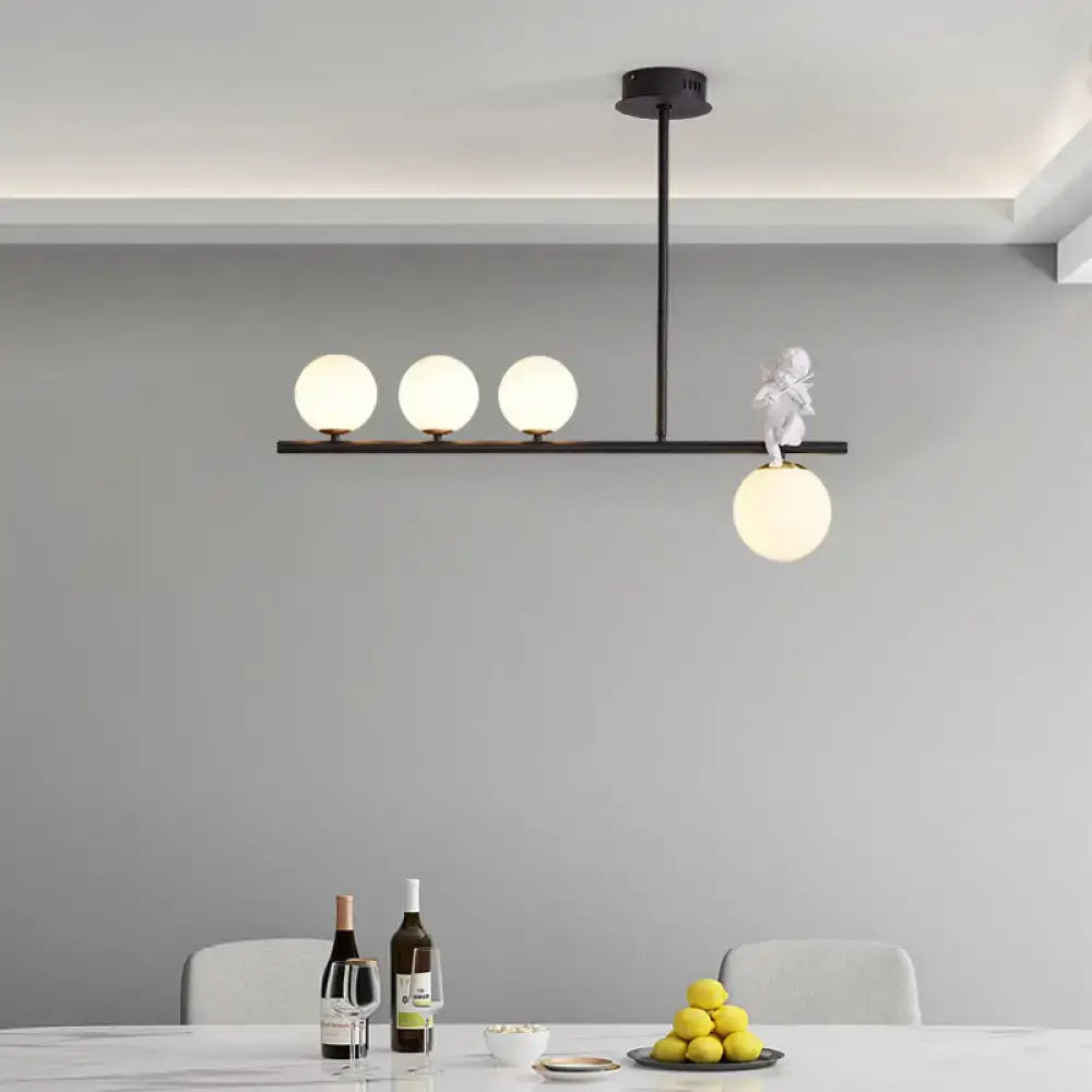 DecorBites™ nordic island pendant light with black metal frame, three spherical opaline glass shades, and white angel figurine
