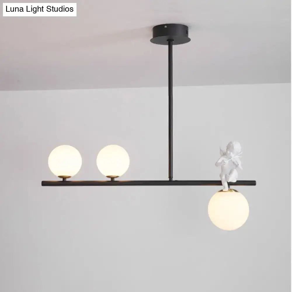 DecorBites™ Nordic Island pendant light with black frame, opaline glass shade, and white cherub on glass globe bulb