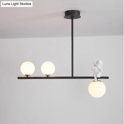 DecorBites™ Nordic Island pendant light with black frame, opaline glass shade, and white cherub on glass globe bulb