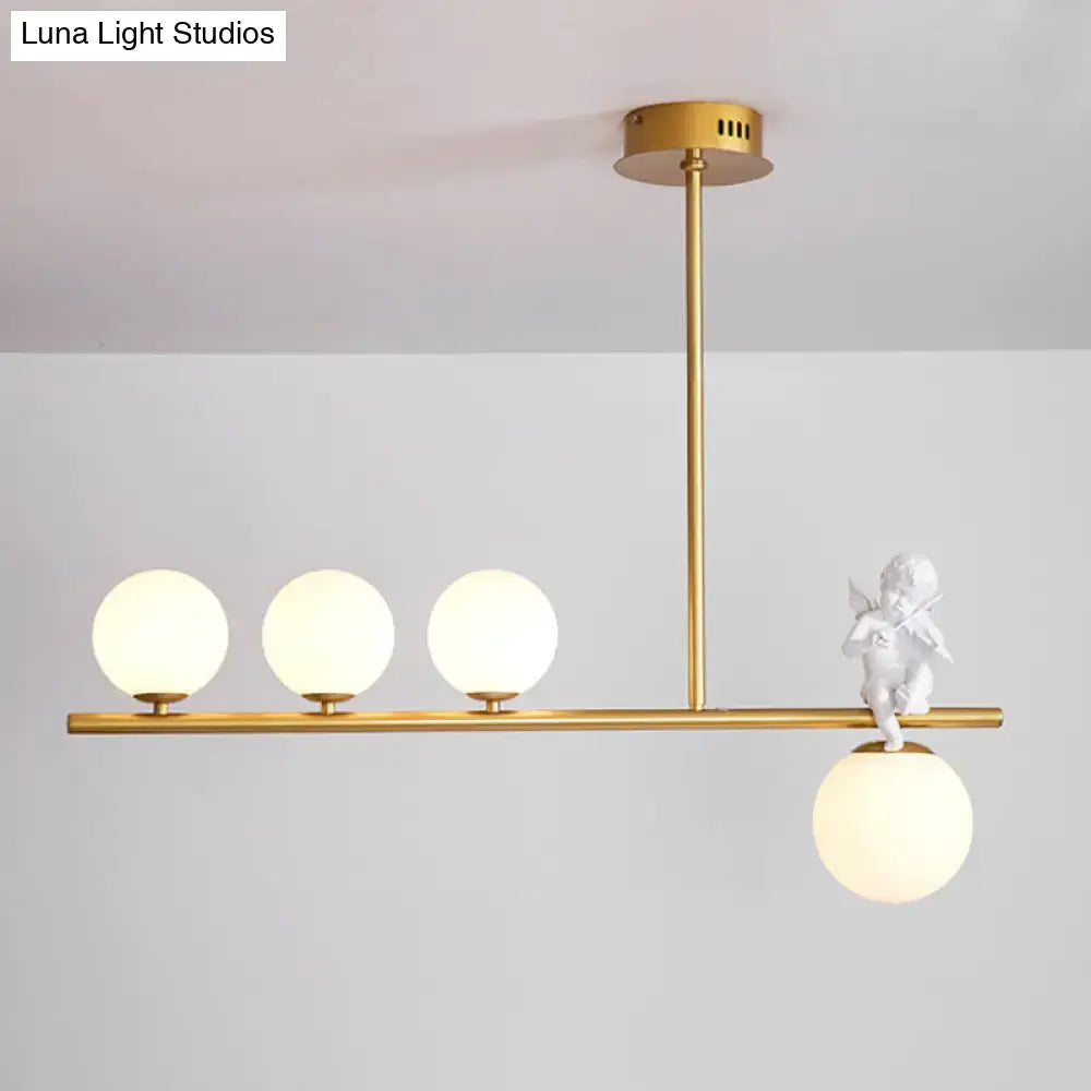 Gold-toned DecorBites™ Nordic Island Angel pendant light with three opaline glass shade bulbs and white cherub figurine