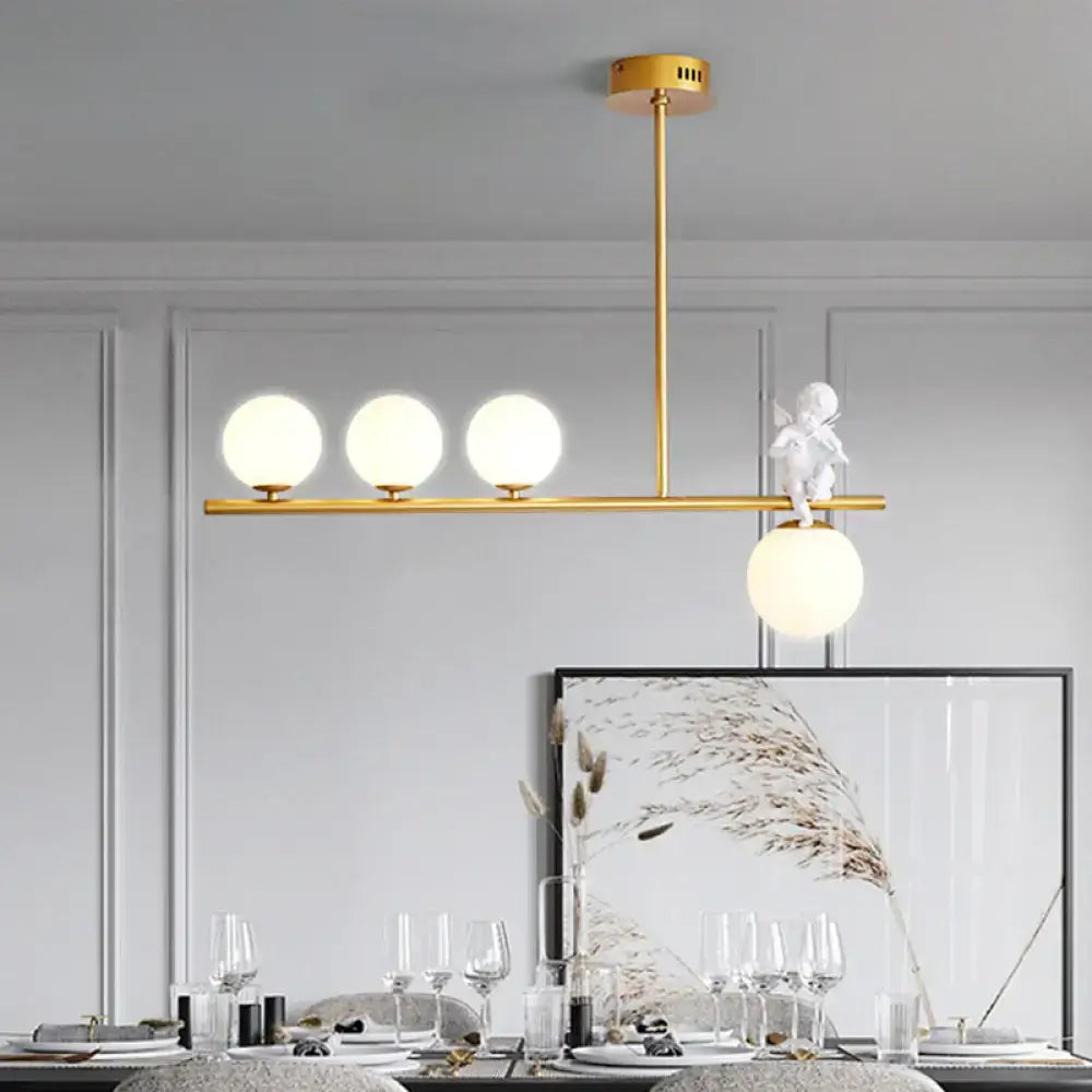 DecorBites Nordic island angel pendant light with gold-toned frame, opaline glass shade, and white cherub figurine