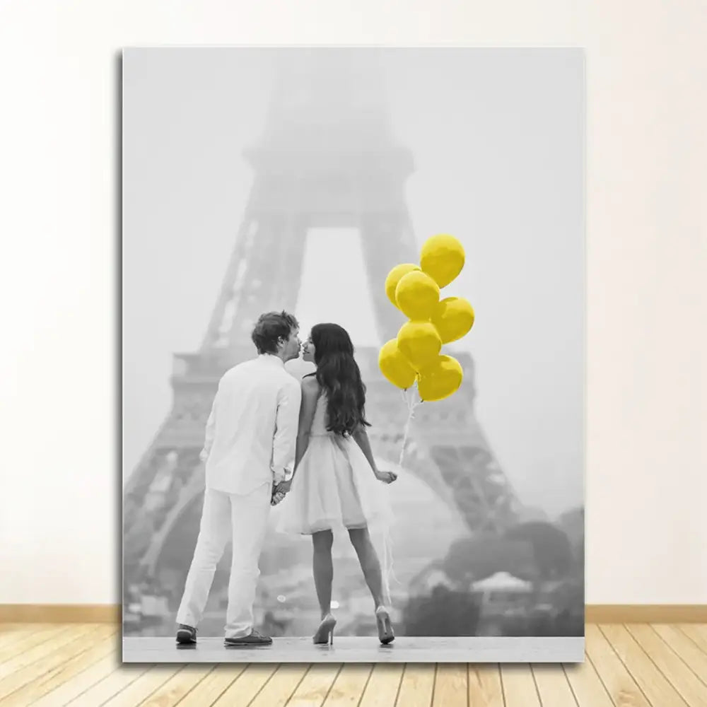 A black-and-white nordic landscape canvas print featuring a couple kissing by the eiffel tower with yellow balloons