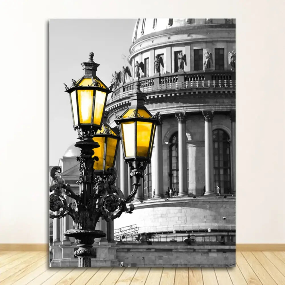 Vintage-style black wrought iron street lamp with three glowing amber lanterns featured in nordic landscape canvas