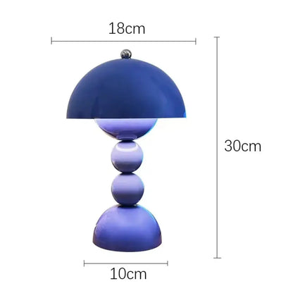 A sleek blue nordic led table lamp with a glossy dome shade and usb dimmable spherical base for bedroom use