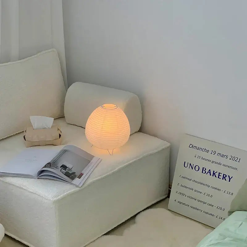 Warmly glowing spherical paper lantern led table lamp with soft orange light for bedroom and living room decor