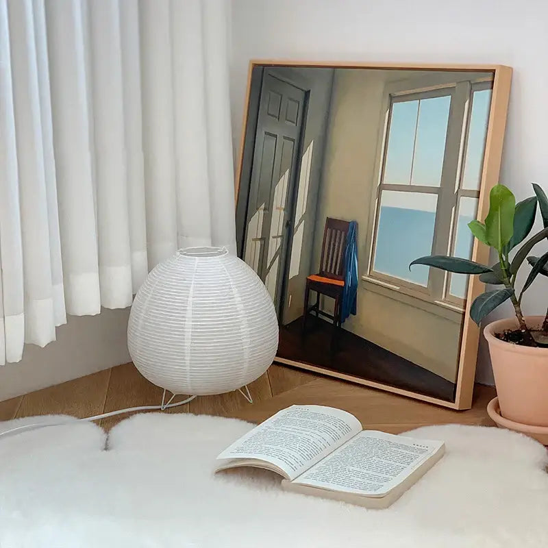 White paper lantern led table lamp with spherical ribbed design and thin metal legs for bedside or study use