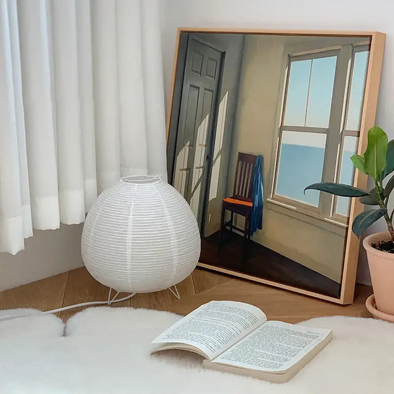 White paper lantern led table lamp with spherical ribbed design and thin wire legs for nordic interior lighting