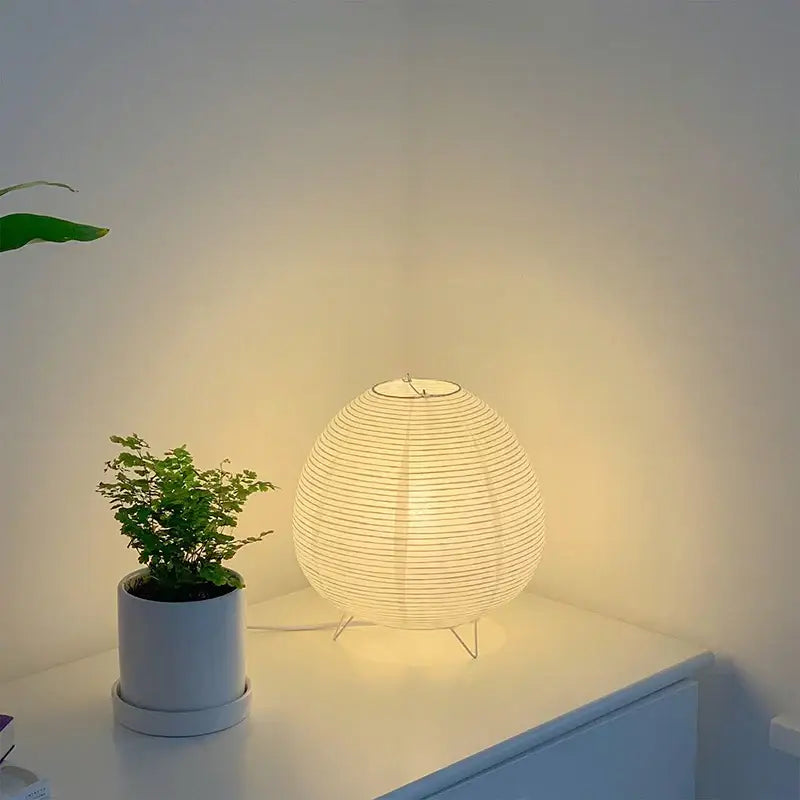 White paper lantern led table lamp with warm glowing light and delicate horizontal ridges for home decor