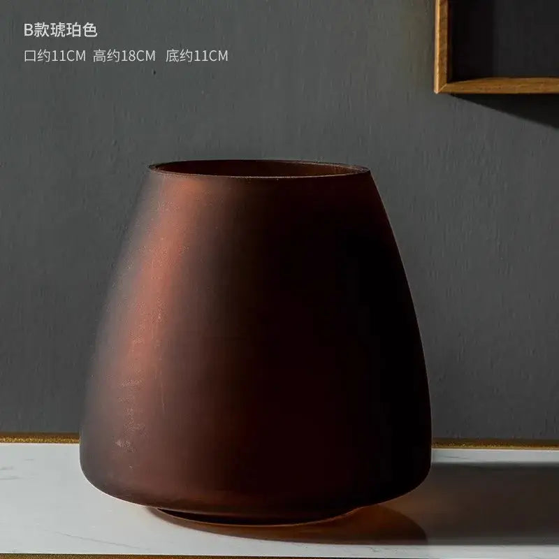 A sleek dark brown matte ceramic vase with a flared rim in the decorbites™ nordic luxe frosted glass vase collection