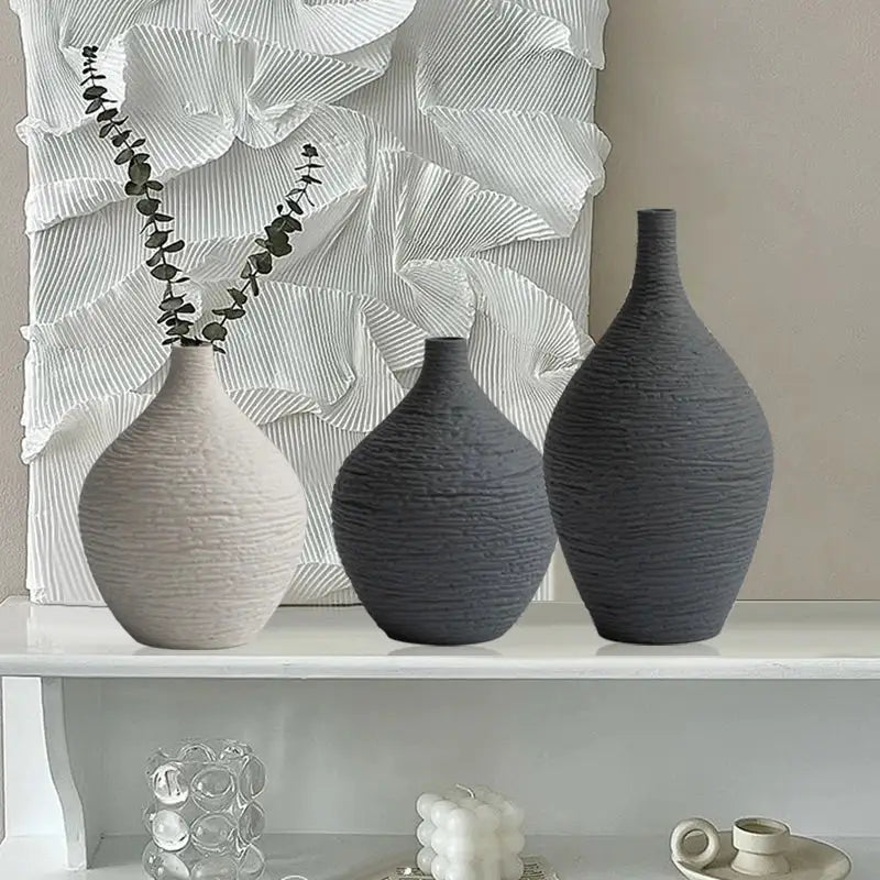 Three textured DecorBites™ nordic luxury ceramic vases in gray and beige with unique ribbed surface designs