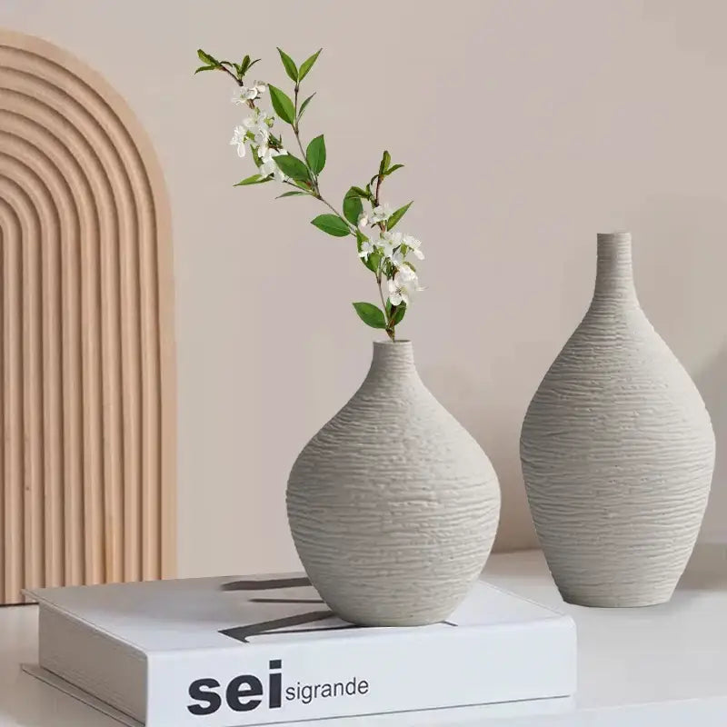 Two off-white textured ceramic vases with ribbed surfaces from decorbites nordic luxury ceramic vase collection for home décor