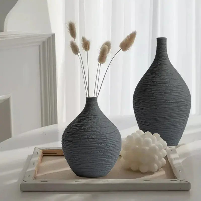 Two textured gray ceramic vases with ribbed surface one holding dried pampas grass decorbites nordic luxury ceramic vase