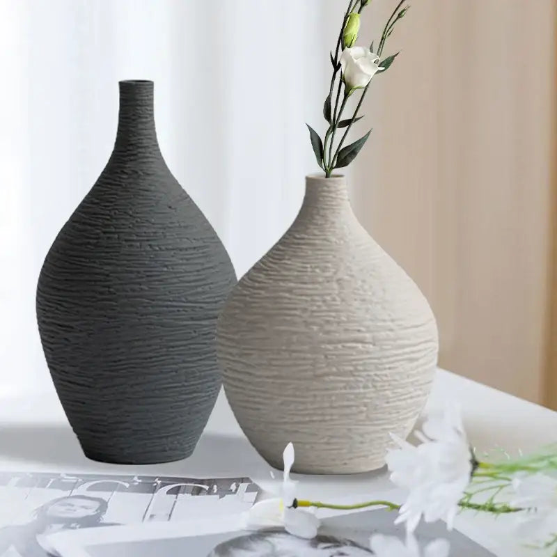 Two nordic luxury ceramic vases by decorbites in dark gray and off-white with textured ribbed surfaces for home décor
