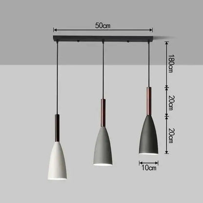 Modern three-light pendant light with black metal bar, matte white and gray shades, copper accents for kitchen island lighting