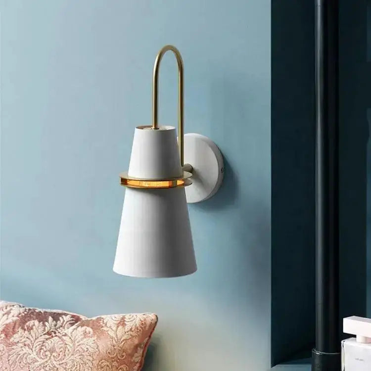 White conical wall lamp with brass arched arm and accent ring by DecorBites minimalist wall lamp design