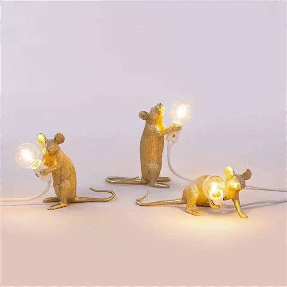 Three golden nordic mouse led table lamps each holding a glowing bulb for stylish ambient lighting