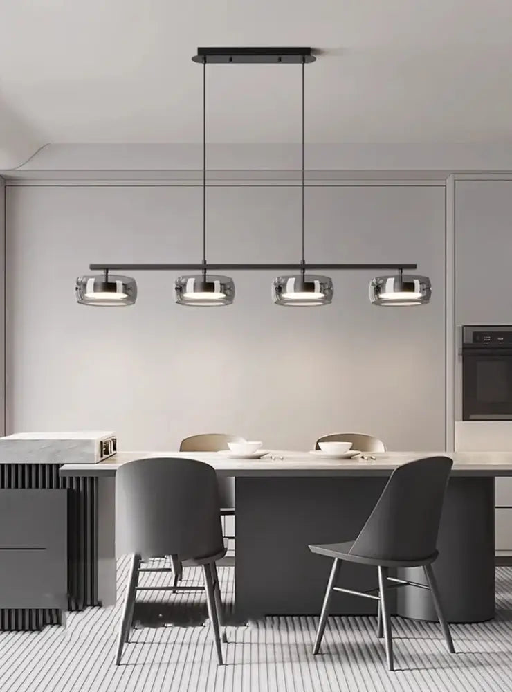 Modern black pendant lamp decorbites™ with four clear glass globes suitable for dining and living rooms with warm white light