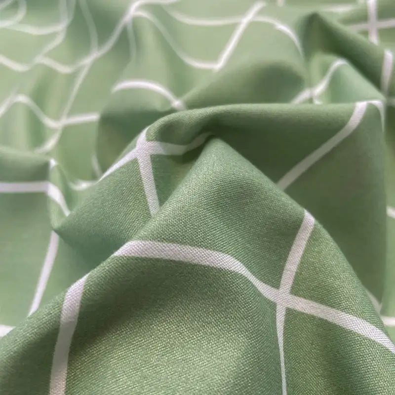 Soft sage green cotton bedding set with subtle white geometric lattice pattern from DecorBites™ nordic plaid collection