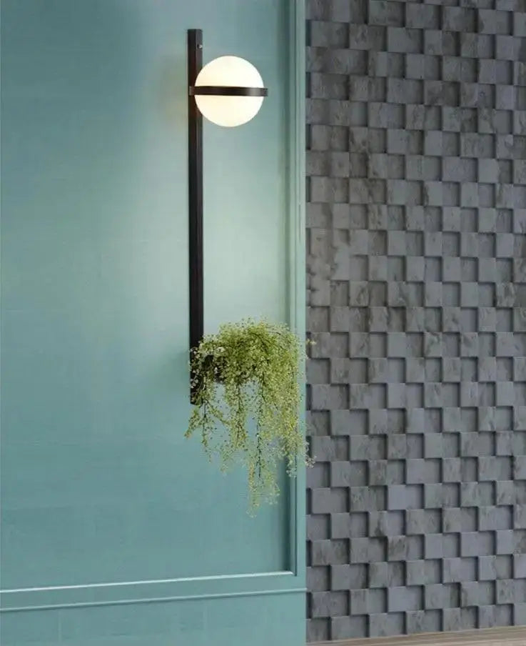 Modern black metal light sconce with a white glass globe and integrated hanging plant nordic planter light by DecorBites