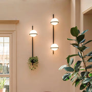 Three decorbites™ nordic planter light sconces with black metal rods and frosted glass globes for stylish lighting