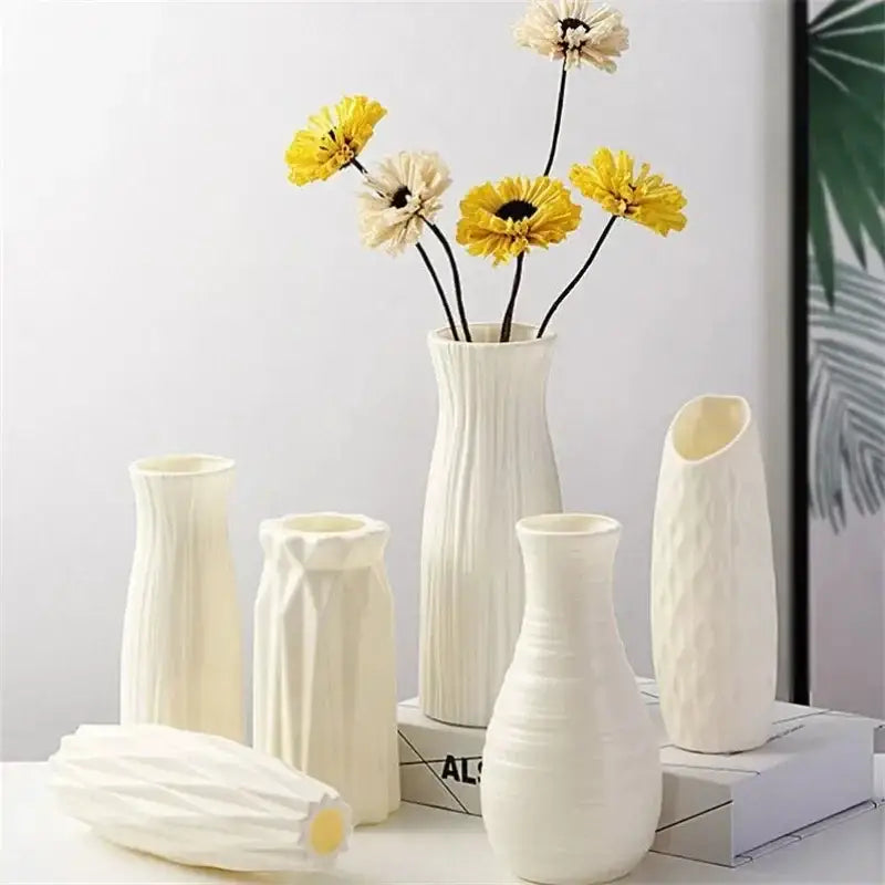 A collection of white nordic plastic vases with varied geometric textures for modern home decor by decorbites