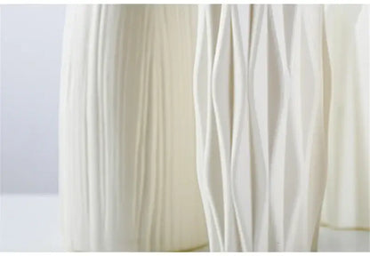 Cream-colored nordic plastic vase with elegant vertically ribbed and wavy textured surface for modern home decor