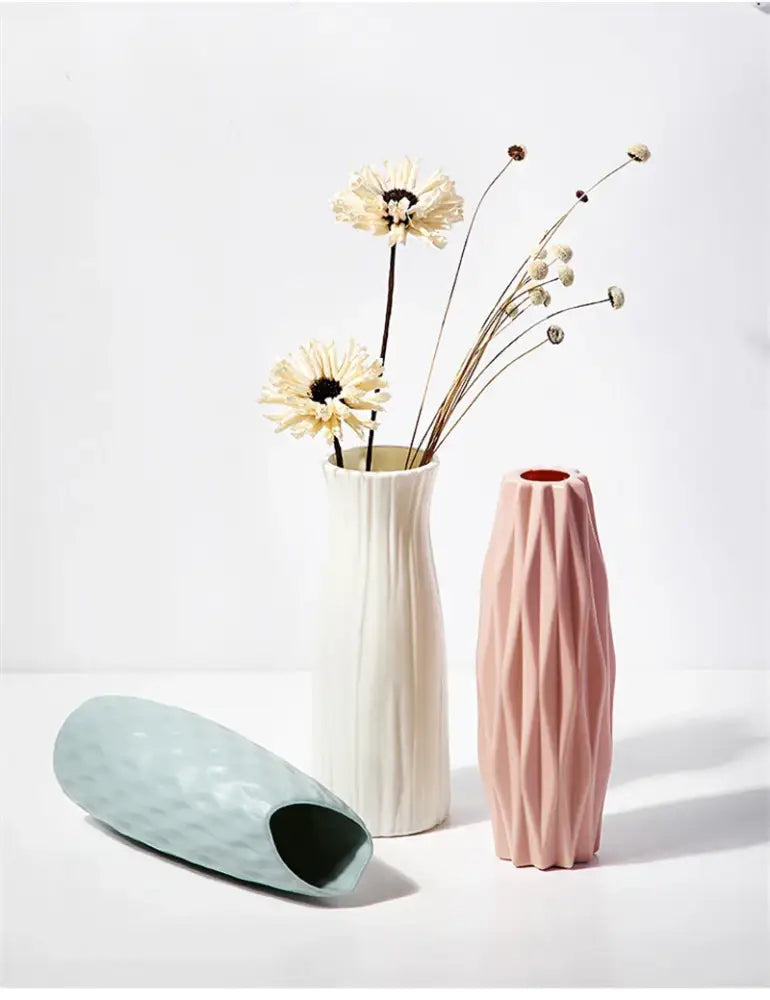 A sleek soft pink matte ceramic vase with geometric diamond pattern from decorbites nordic plastic vase collection